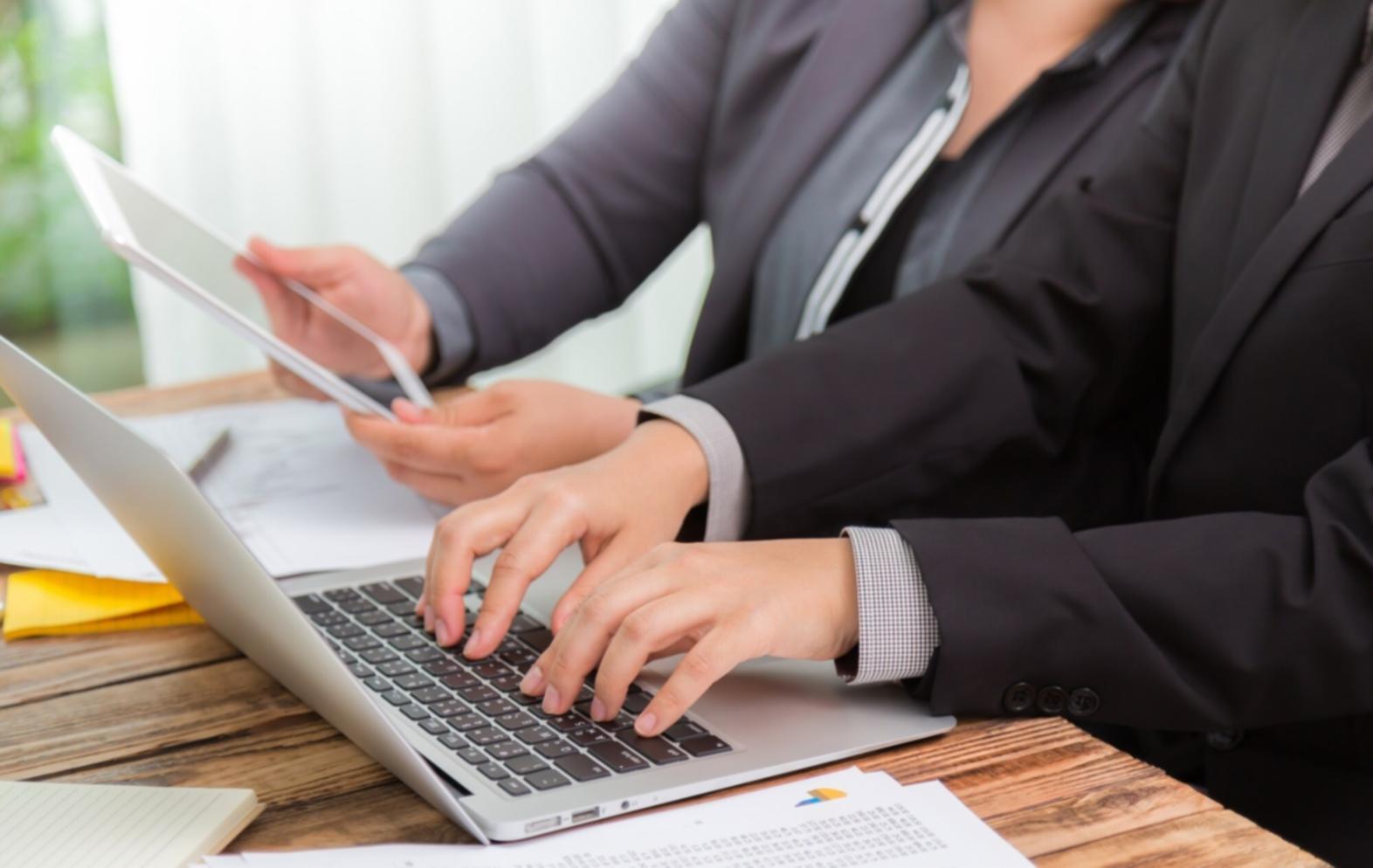 Investment analysis workspace showing financial charts and research materials